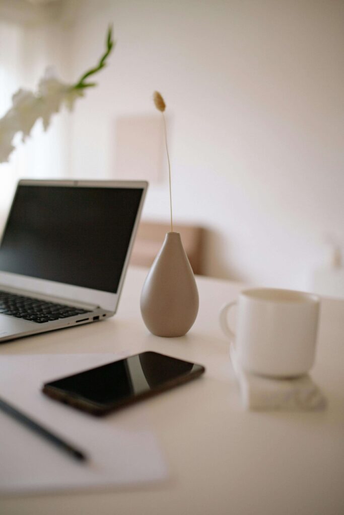 seo web design tips with a photo of a phone, laptop, and coffee