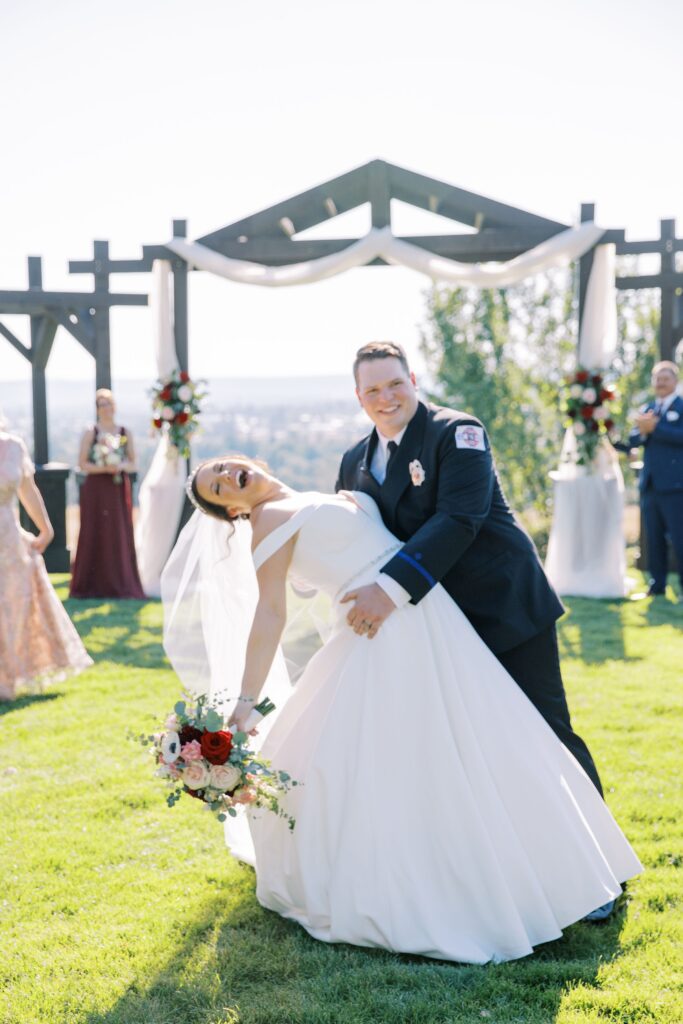 couple dipping at wedding ceremony