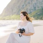 photographer holding camera in Hawaii to show marketing strategy for photographers