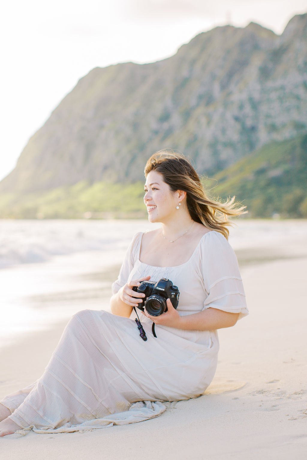 photographer holding camera in Hawaii to show marketing strategy for photographers