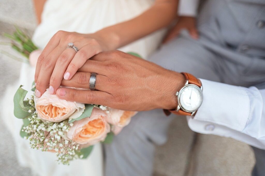 couple holding hands on wedding day to show seo for wedding planners